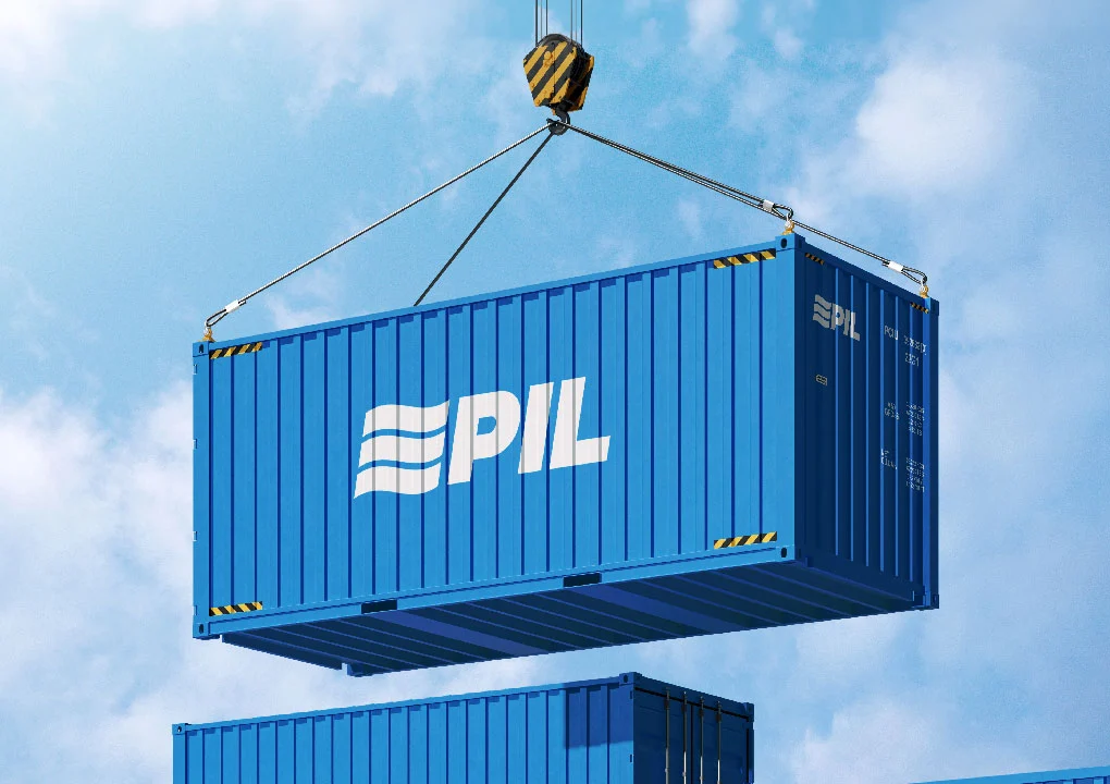 A blue shipping container with the PIL logo lifted by a crane against the sky